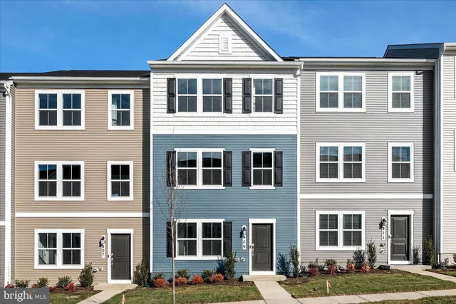 a front view of a building with a yard