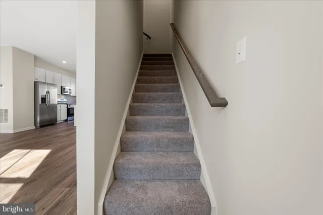 a bathroom with a granite countertop sink mirror and toilet