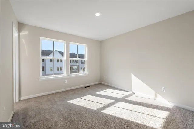 an empty room with an entrance to other room