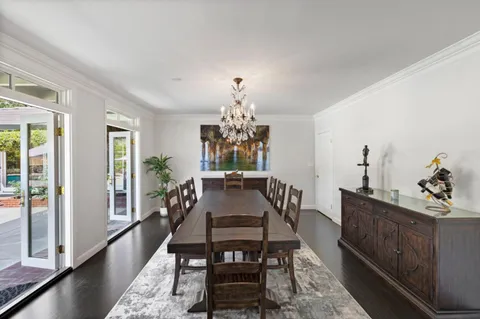 a view of a hallway and a livingroom with furniture