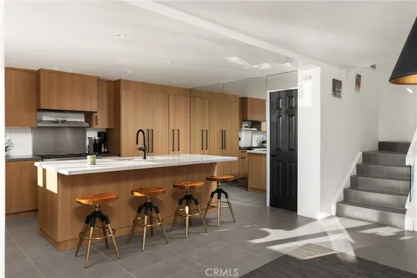 a kitchen with appliances a sink and cabinets