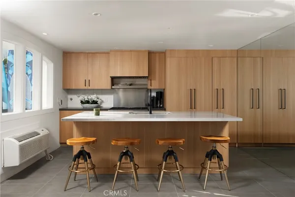 a kitchen with a table chairs refrigerator and cabinets