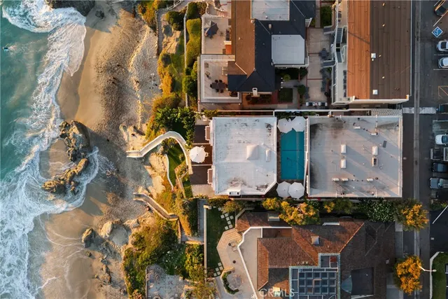 an aerial view of residential houses with outdoor space and parking