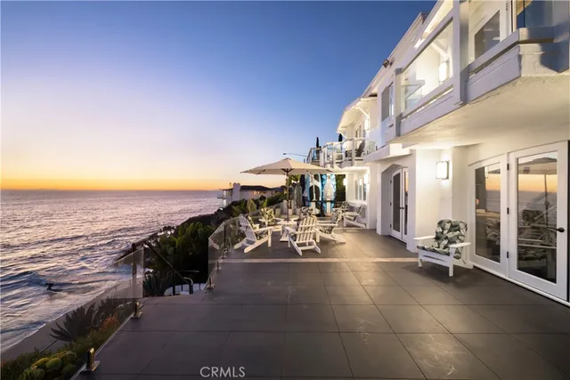a view of a terrace with lawn chairs
