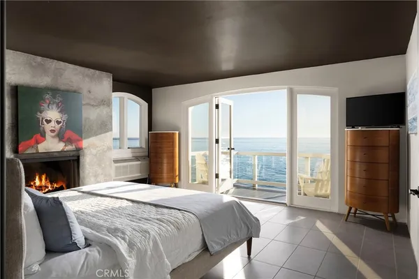 a bedroom with a large bed and a fireplace