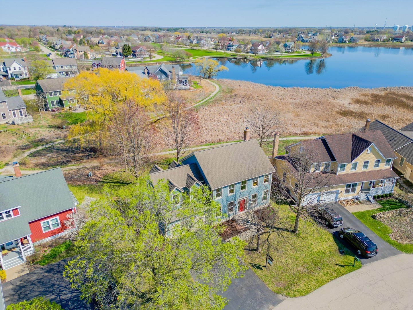 an aerial view of residential houses with outdoor space and river