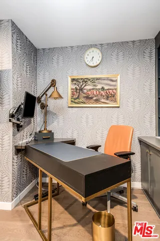 a view of a roof deck with table and chairs under an umbrella