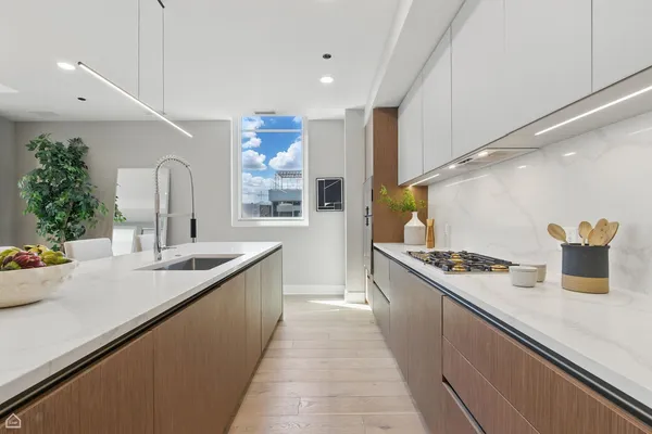 a kitchen with stainless steel appliances a sink and a stove