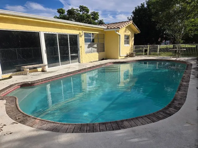 a view of a swimming pool with a outdoor seating