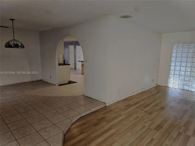 a view of a room with wooden floor