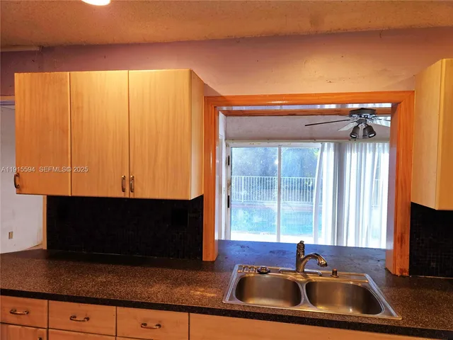 a kitchen with a sink a counter top space and a window