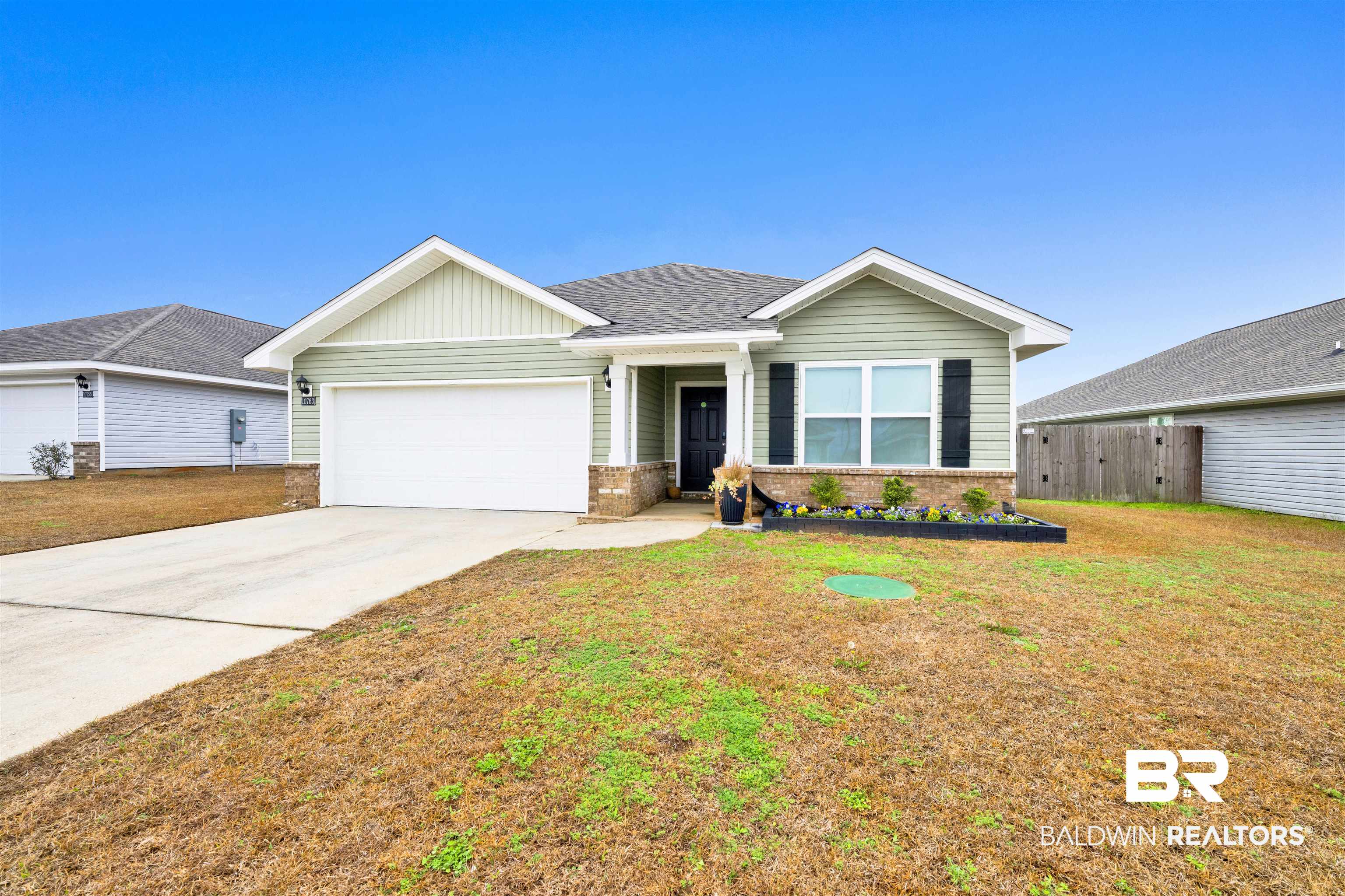 10763 Paget Drive North Mobile, AL 36608 - Photo 1 of 24 Single story home with brick siding, an attached garage, driveway, and a shingled roof