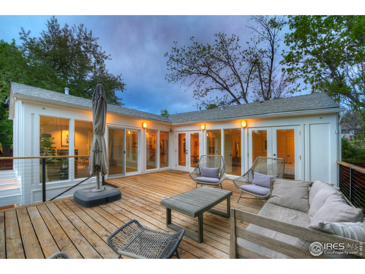 2350 Panorama Avenue Boulder, CO 80304 - Photo 16 of 39 a view of a dining room with furniture large windows and wooden floor