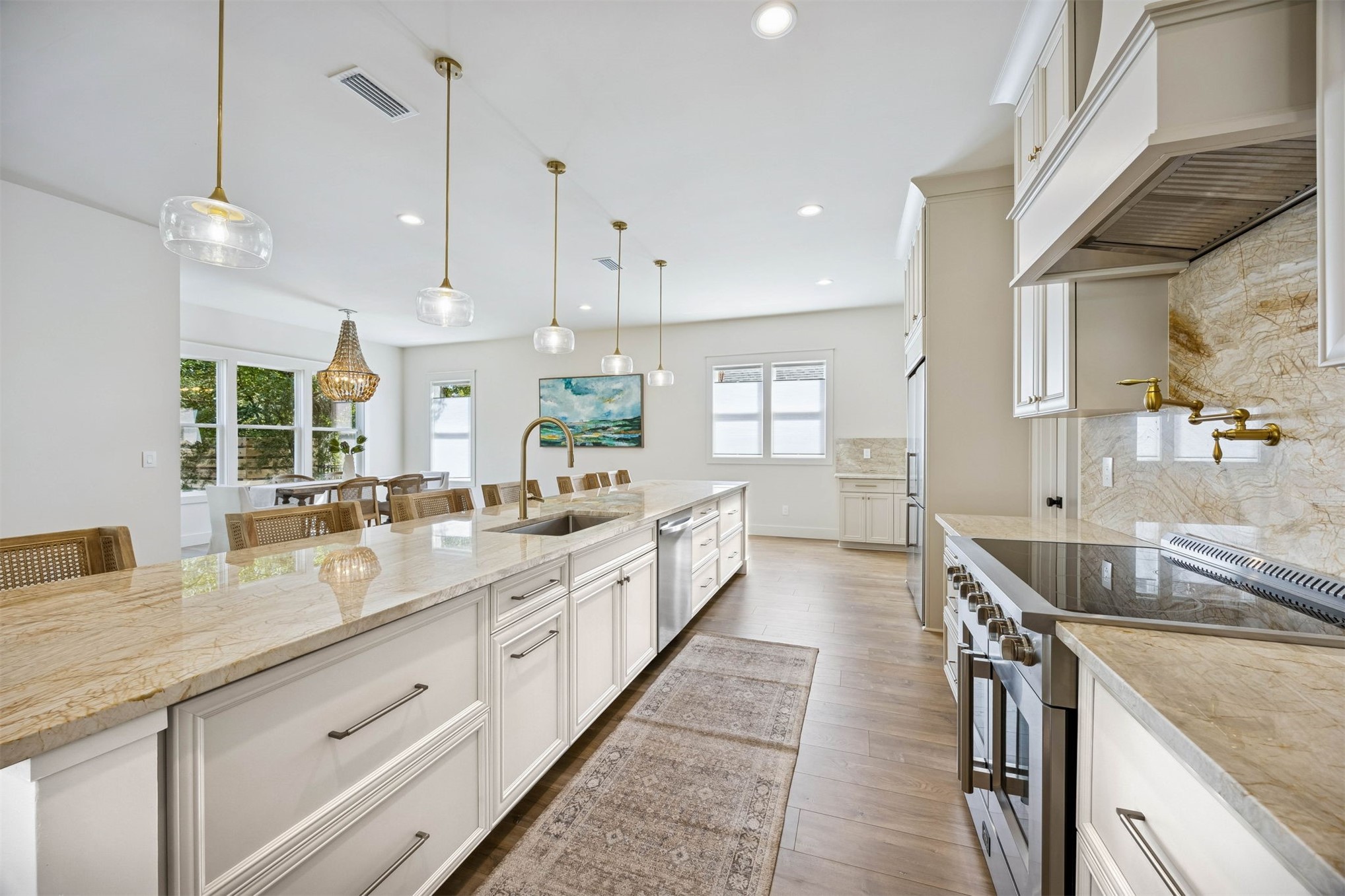 424 South 3rd Street Fernandina Beach, FL 32034 - Photo 6 of 38 a large kitchen with kitchen island a large counter space a sink stainless steel appliances and windows