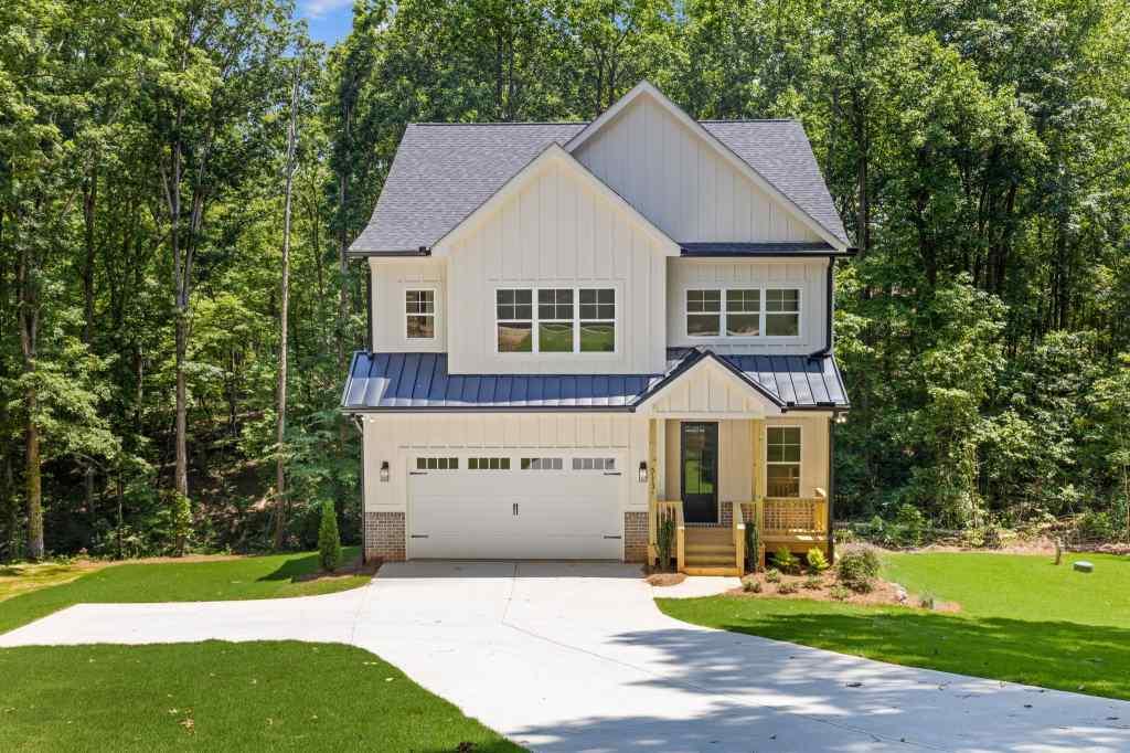 5113 Lee Road Gainesville, GA 30506 - Photo 1 of 1 a front view of a house with a yard and trees