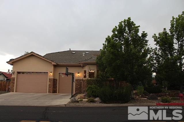 a view of a house with yard and tree in the background
