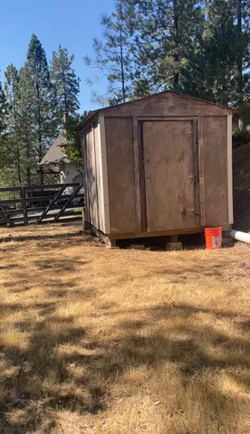 a view of large tree with wooden fence