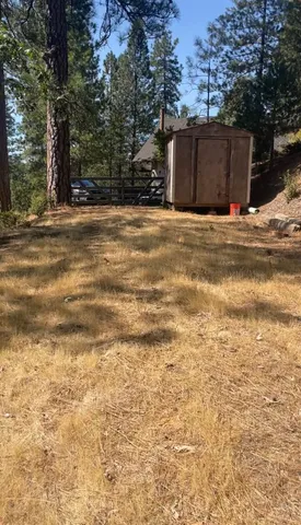 a wooden fence under a large tree