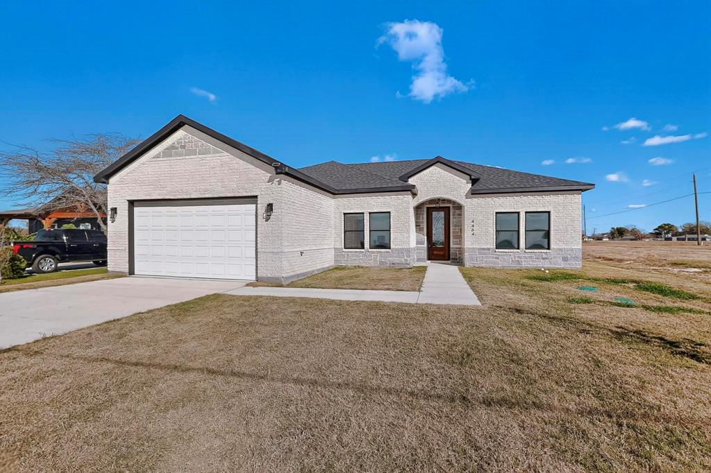 4464 Key Ranch Road Trinidad, TX 75163 - Photo 3 of 40 View of front of house featuring driveway, a front lawn, brick siding, and an attached garage