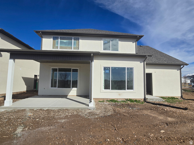 1651 West Ross Road Syracuse, UT 84075 - Photo 3 of 15 Back of house featuring stucco siding, roof with shingles, and a patio area