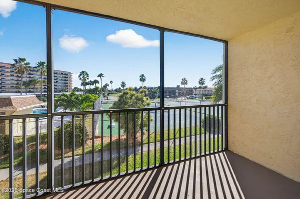 a view of a balcony with floor to ceiling window wooden floor