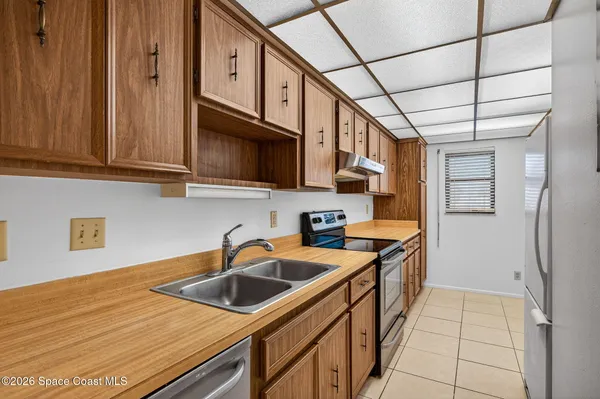 a kitchen with stainless steel appliances granite countertop a sink a stove and a microwave oven