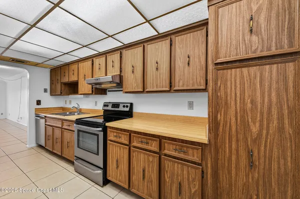 a kitchen with stainless steel appliances granite countertop wooden cabinets a sink and dishwasher