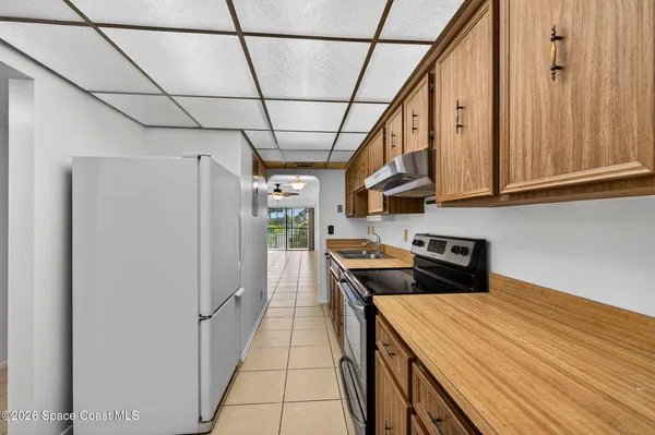 a kitchen with stainless steel appliances a refrigerator and a stove top oven