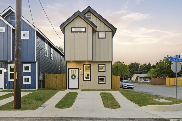 a street view with tall buildings and a street sign on a wall