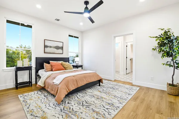 a bedroom with a bed and a potted plant