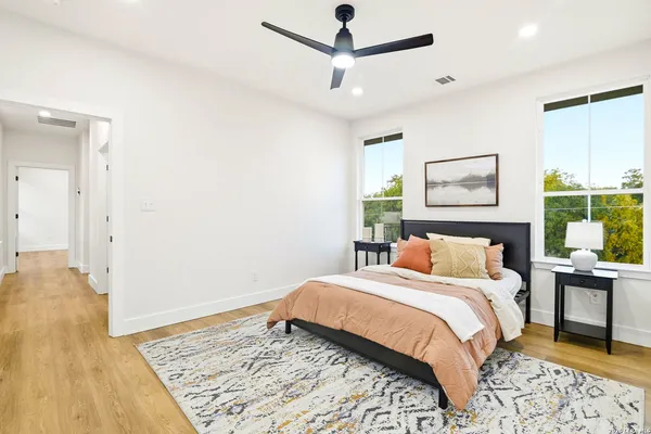 a bedroom with a bed dresser and a window