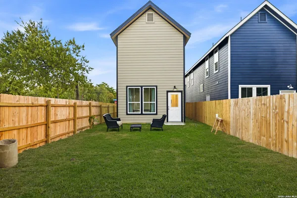 a view of an house with backyard space and a garden