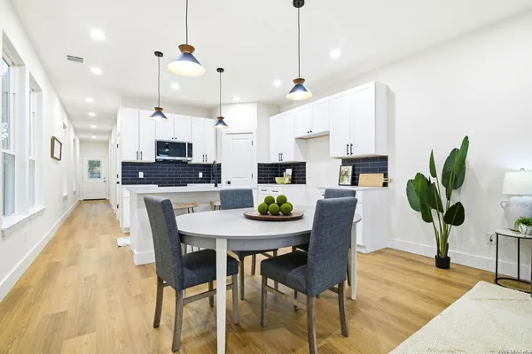 a view of a dining room and furniture with wooden floor