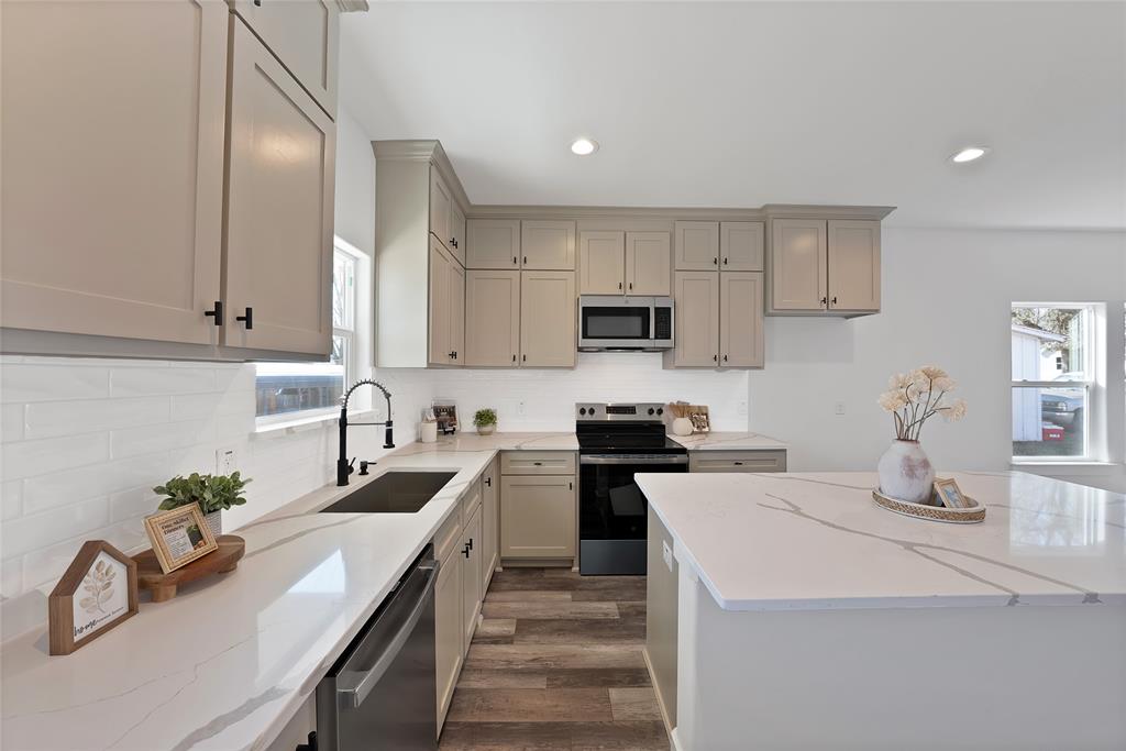 175 Harris Harbor Road East Tawakoni, TX 75472 - Photo 10 of 22 a kitchen with sink a stove and cabinets