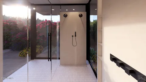a view of a hallway with wooden floor and a bathroom