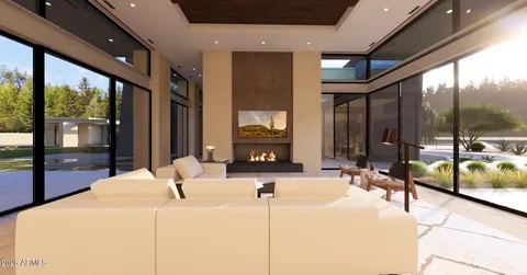a living room with furniture large window and kitchen view
