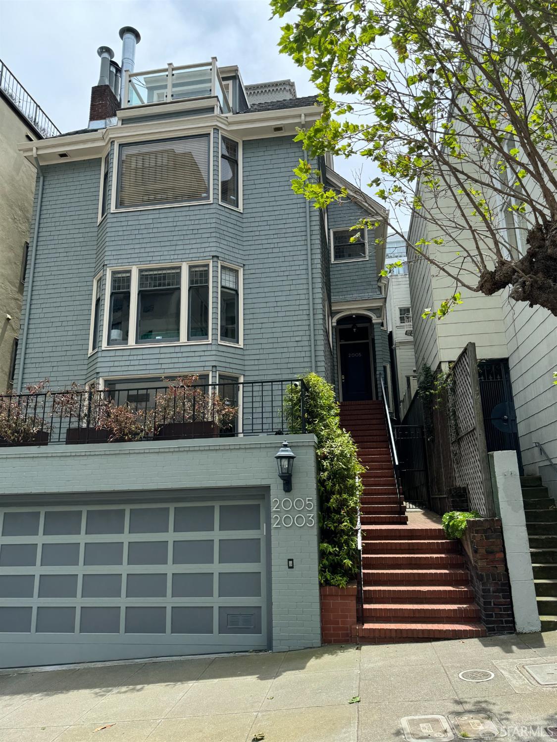 a front view of a house with stairs