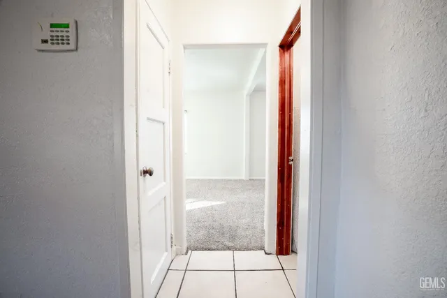 a view of a hallway with wooden shelves
