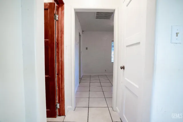 an empty room with windows and entrance