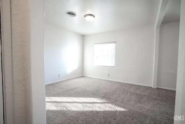 a view of an empty room with a fireplace