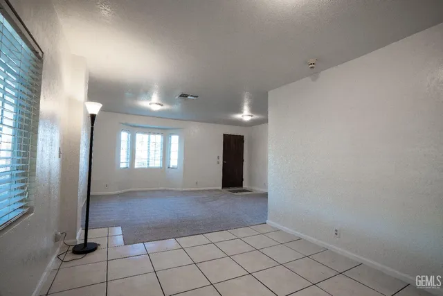 a view of a hallway with wooden floor and closet