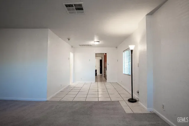 a bathroom with a granite countertop toilet and a sink
