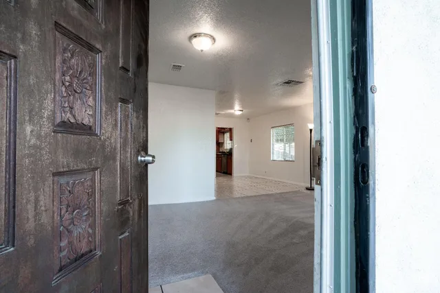 an empty room with windows and closet