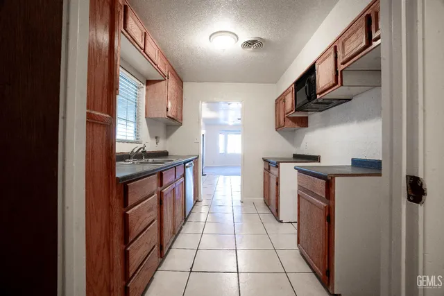 a kitchen with stainless steel appliances granite countertop a stove and a refrigerator
