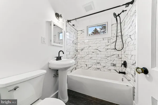 a bathroom with a sink a toilet and a bathtub