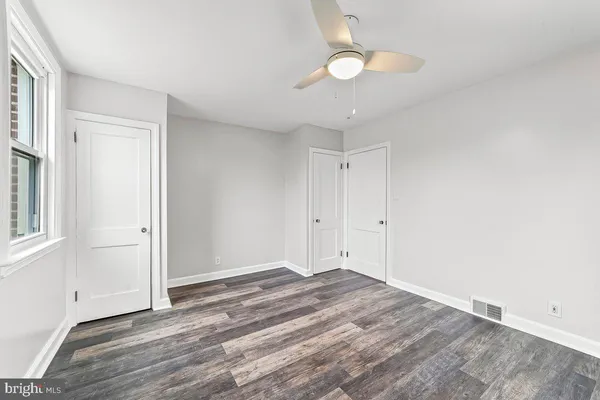 a view of empty room with wooden floor