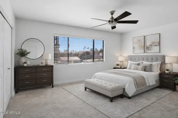a spacious bedroom with a bed and window