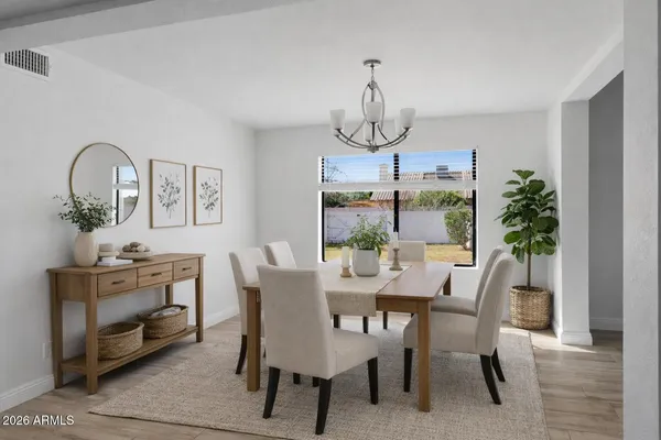 a view of a dining room with furniture window and flowerpot