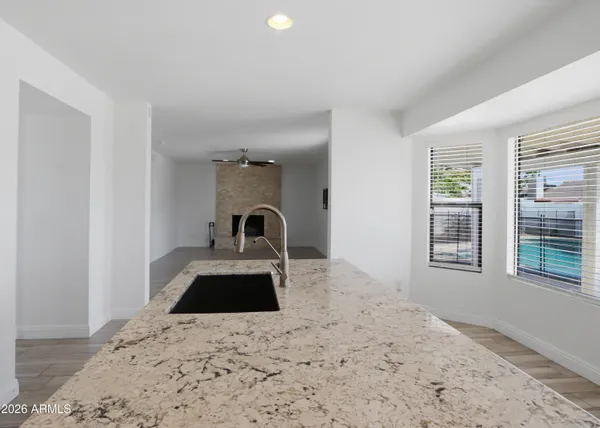 a kitchen with a refrigerator and a sink