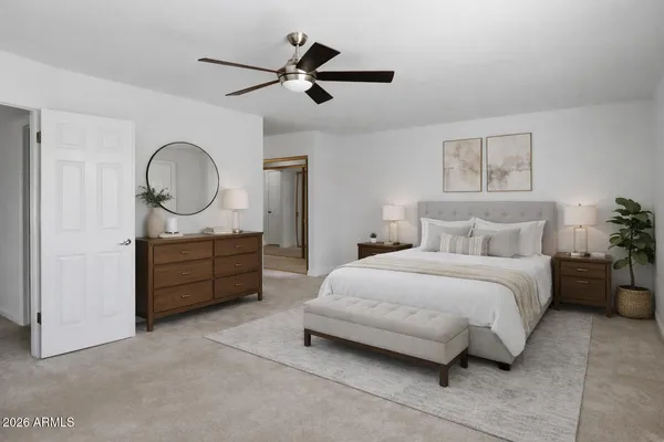 a bedroom with a bed mirror and window